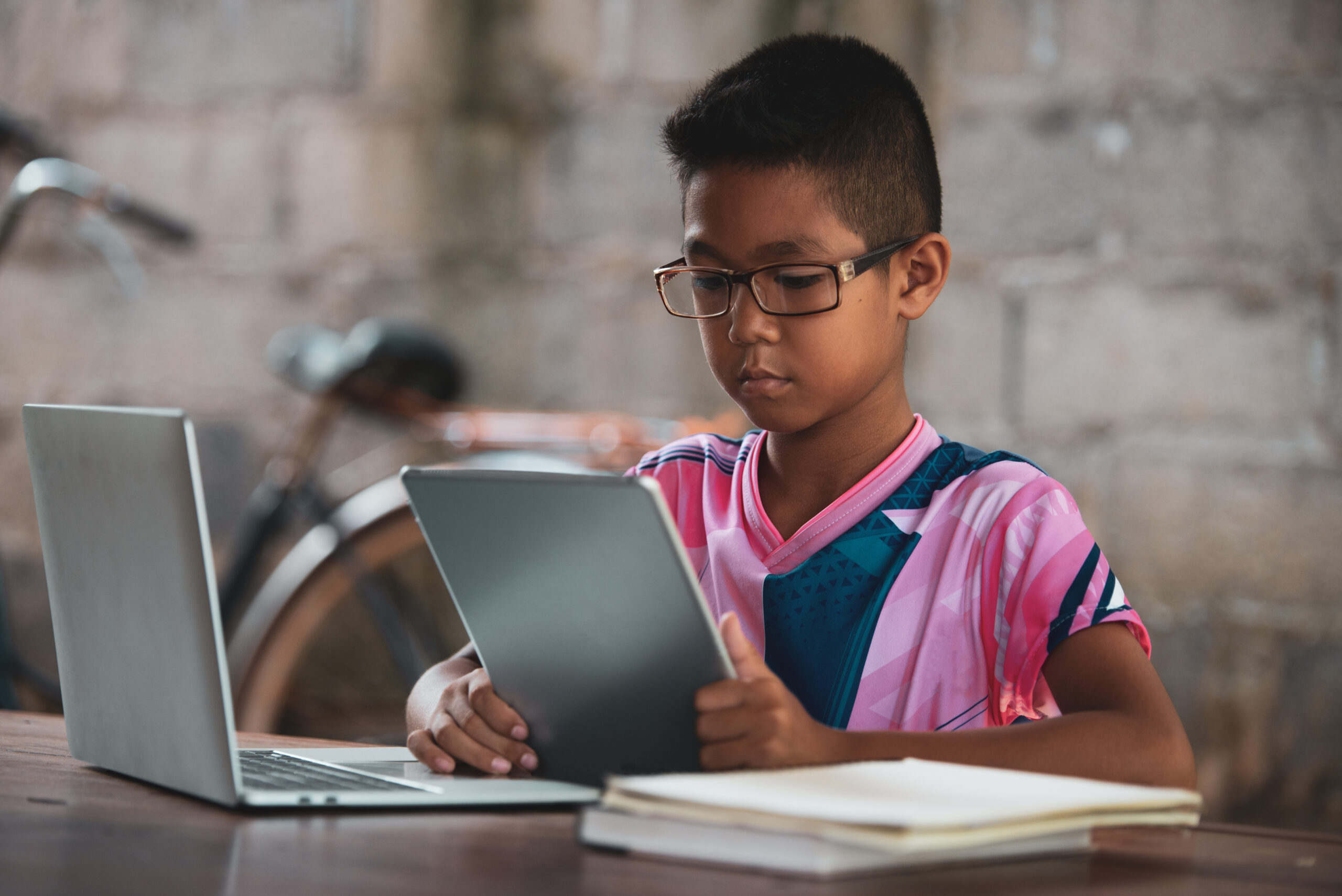 Asian boy using laptop on the table,come back to shcool